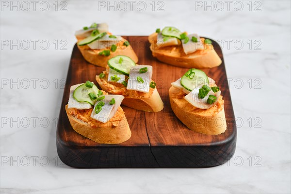 Little sandwiches with pieces of Clupeidae and spring onion