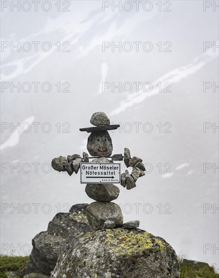 Figure made of stones with a face, signpost to the Grosser Moeseler summit, mountaineer on a hiking trail, Furtschaglhaus, Berliner Hoehenweg, Zillertal, Tyrol, Austria, Europe