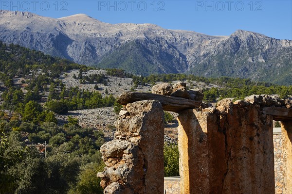Remains of an ancient wall against a mountain backdrop under a blue sky, Aradena Gorge, Aradena, Sfakia, Crete, Greece, Europe