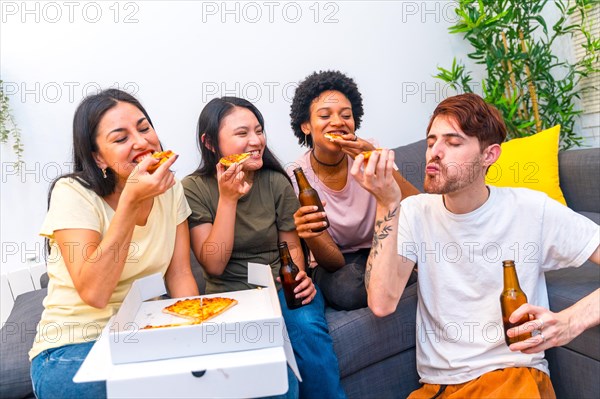 Multicultural friends enjoying a perfect weekend with a delicious pizza and beer at home