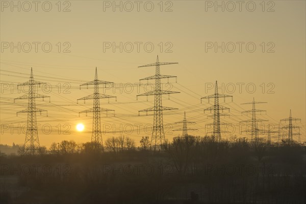 Power pylons, overhead lines, energy supply, sunrise, sun, vineyard, field, Baden-Wuerttemberg, Germany, Europe