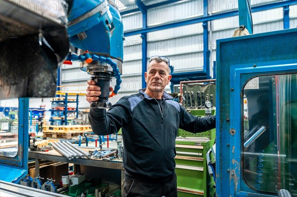 Expert of Male Software engineer working in front of automated CNC machine