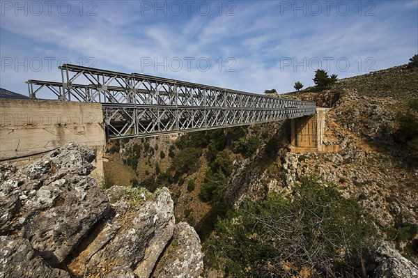 Steel bridge spans a rocky gorge under a blue sky, Aradena Gorge, Aradena, Sfakia, Crete, Greece, Europe