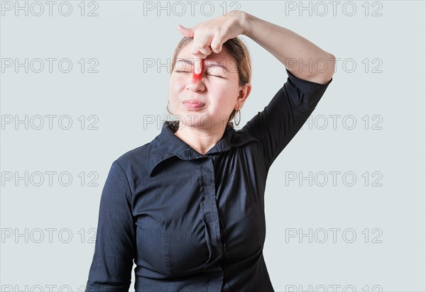 Young woman with pain touching nose. People with nasal bridge pain, Girl with nasal bridge headache. Sinus pain concept