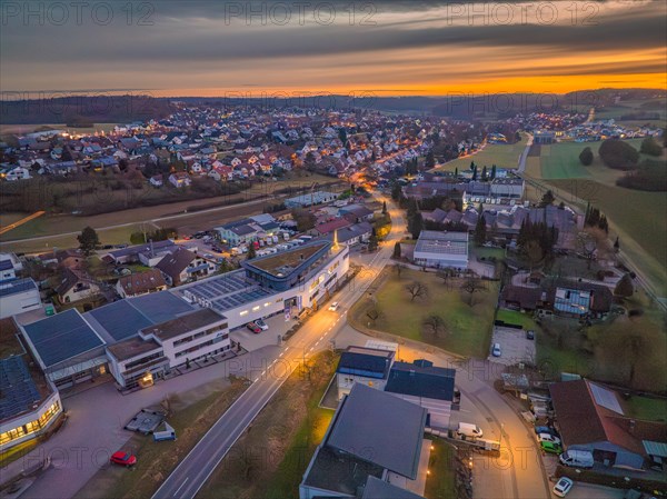 Evening aerial view of a town with illuminated streets, Christmas tree on the roof, Black Forest, Gechingen, Germany, Europe