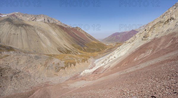 Mountain landscape of glacial moraines, mountains with red and yellow rocks, Traveller's Pass below Lenin Peak, Trans Alay Mountains, Pamir Mountains, Osh Province, Kyrgyzstan, Asia