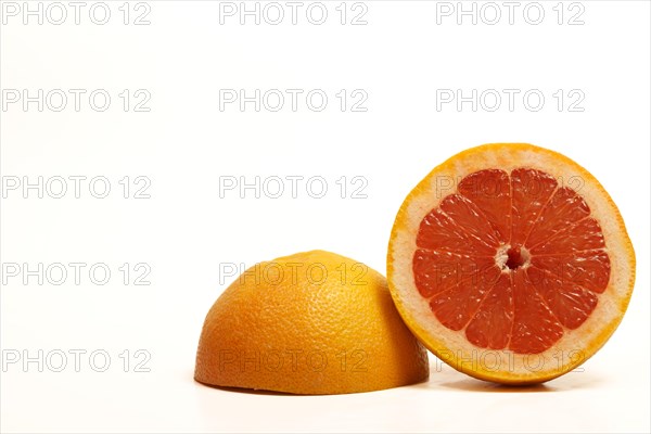 Close-up of a fresh grapefruit cut in half isolated on white background and copy space