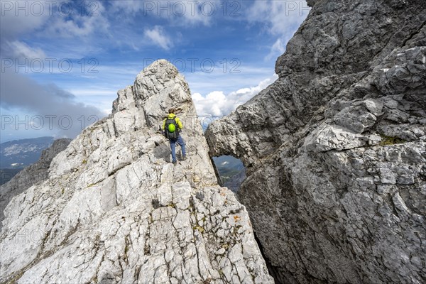 Mountaineer on a narrow rocky ridge, Watzmann crossing to Watzmann Mittelspitze, view of mountain panorama, Berchtesgaden National Park, Berchtesgaden Alps, Bavaria, Germany, Europe