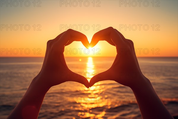 Two hands forming a heart shape, silhouetted against a breathtaking ocean sunset. Love and warmth on Valentine's Day or any romantic occasion, AI generated