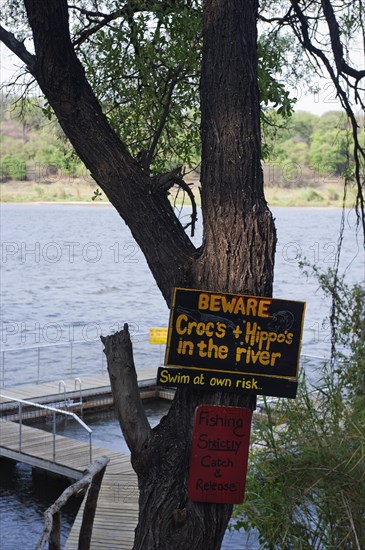 Warning of crocodiles and Hippopotamuses, swimming, bathing, danger, danger to life, pool, river in Ngepi camp, Divundu in Namibia
