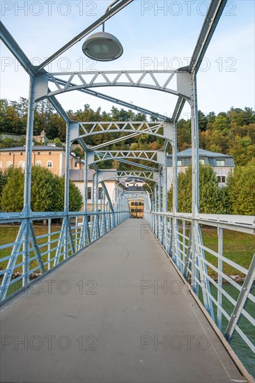 Pedestrian bridge with blue steel construction and clear sky in the background, Mozartsteg Salzburg, Austria, Europe