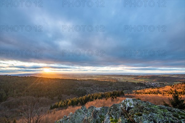 Landscape at the Grosser Zacken, Taunus volcanic region. A cloudy, sunny autumn day, meadows, hills, fields and forests with a view of the sunset. Hesse, Germany, Europe