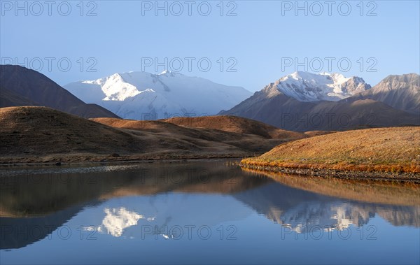 Morning atmosphere, mountains reflected in a small mountain lake, Pik Lenin, Trans Alay Mountains, Pamir Mountains, Osh Province, Kyrgyzstan, Asia