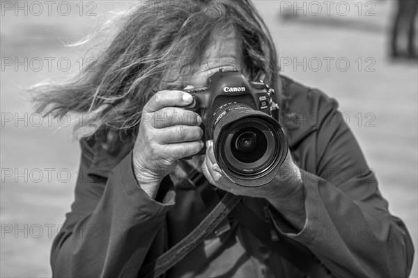 Photographer taking pictures in Piazza de Ferrari, Genoa, Italy, Europe