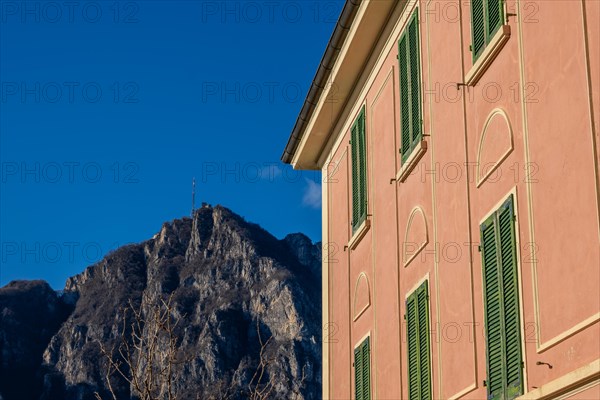 Old Building with Window Against Blue Clear Sky and Mountain Peak San Salvatore in Campione d'Italia, Lombardy, Italy, Europe