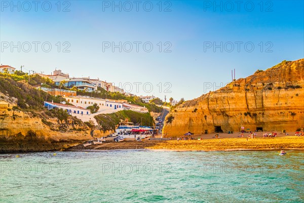 Beautiful limestone cliff Algarve coast with village of Benagil, south of Portugal