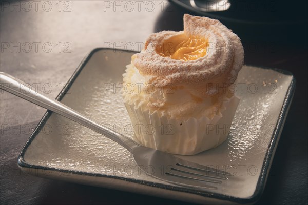 Close up of a brazo de mercedes cupcake, a popular authentic Filipino dessert. Dipolog, Philippines, Asia
