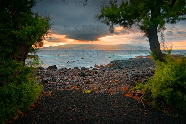 Sunset over the coast of Madalena with volcanic sandy beach and trees, Madalena, Pico, Azores, Portugal, Europe