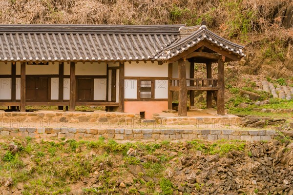 Traditional Korean style building with ceramic tiled roof and open air porch in countryside