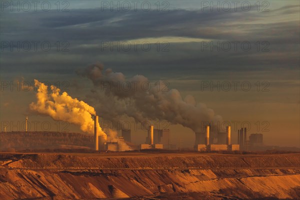 Chimneys emitting smoke in a twilight industrial landscape, open-cast lignite mine, North Rhine-Westphalia, Germany, Europe