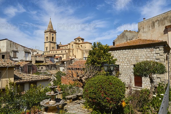 Panoramic view of old roofs and church towers of a small town with green vegetation, Novara di Sicilia, Sicily, Italy, Europe