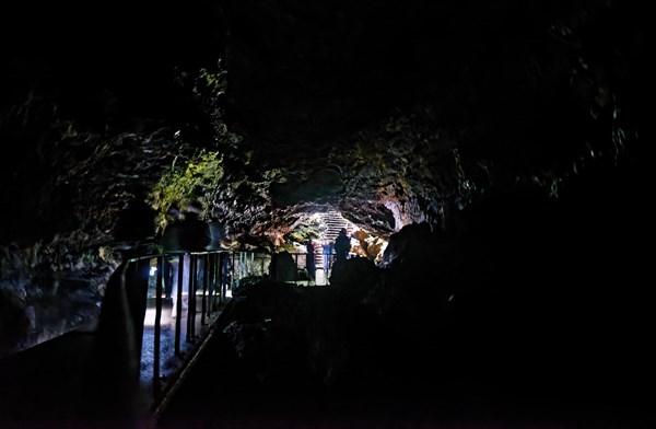 People walking to the cave exit in the lava tunnel Gruta das Torres, Gruta das Torres, Pico, Sao Miguel, Faial, Azores, Portugal, Europe