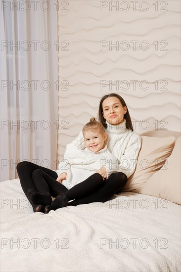 Lifestyle portrait of happy young family wearing similar clothes