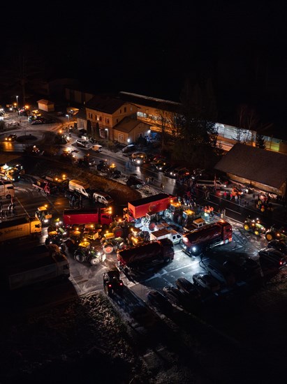 Night view of an illuminated road full of tractors and people, farmers protest, Black Forest, Bad Teinach, Germany, Europe