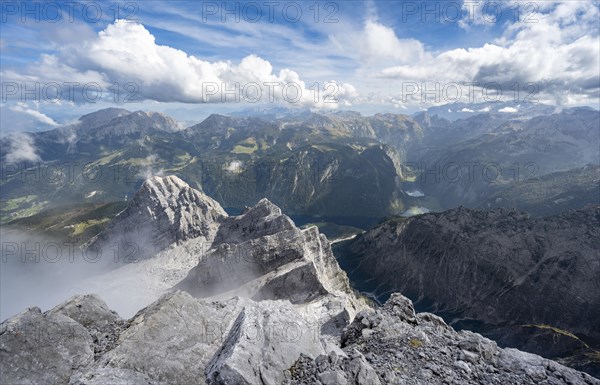 View from the rocky summit of the Watzmann Mittelspitze, view of mountain panorama with Steinernes Meer and Koenigssee, Kleiner Watzmann and Watzmann Kinder, Watzmann crossing, Berchtesgaden National Park, Berchtesgaden Alps, Bavaria, Germany, Europe