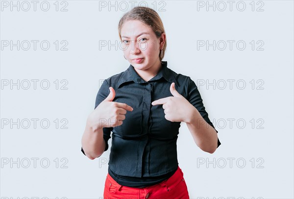 Embarrassed girl pointing at herself isolated. Confused latin girl pointing at herself isolated