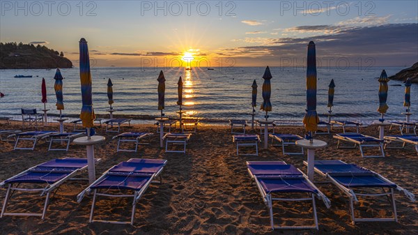 Sun loungers and parasols on Straccolignino beach at sunrise, near Capoliveri, Elba, Tuscan Archipelago, Tuscany, Italy, Europe