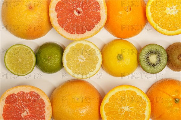 Photographic background of fruit cut in half with white background. orange, grapefruit, kiwi, lime, lime, lemon