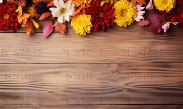 Fall leaves and flowers arranged on a rustic wooden background AI generated