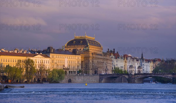 Beautiful National Theatre building and Vltava river in the city center of Prague, Czech Republic (Czechia), at sunset