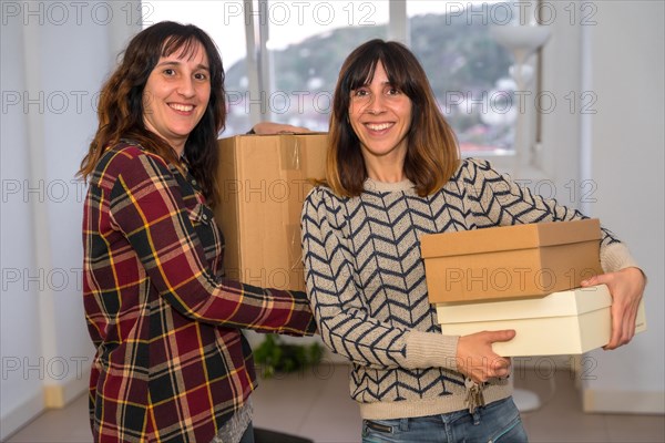 Portrait of a female friend helping a woman to move house