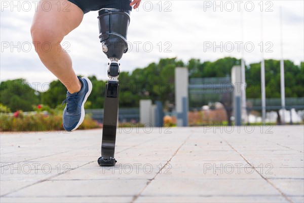 Cropped photo of the prosthetic legs of a runner in an urban park