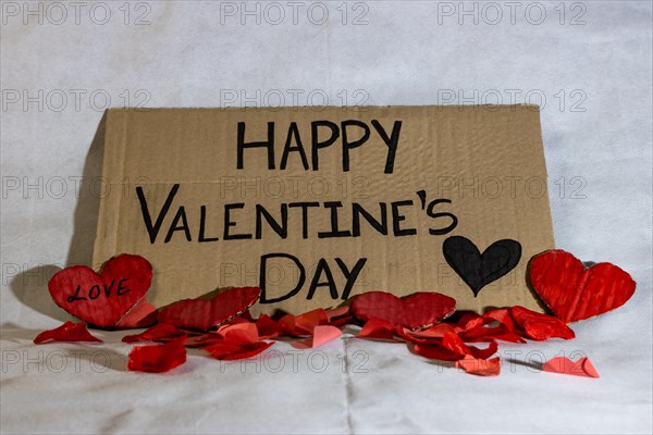 Cardboard sign Happy Valentine's Day isolated. Text of Happy Valentine's Day written on a cardboard