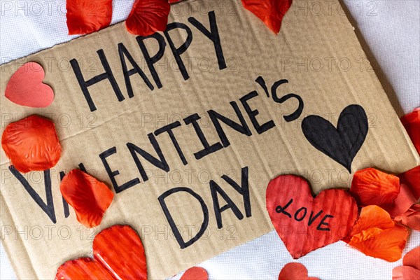 Cardboard sign Happy Valentine's Day isolated. Text of Happy Valentine's Day written on a cardboard