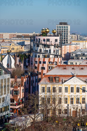 Hundertwasser House Green citadel with golden spheres stands out between buildings, Magdeburg, Saxony-Anhalt, Germany, Europe