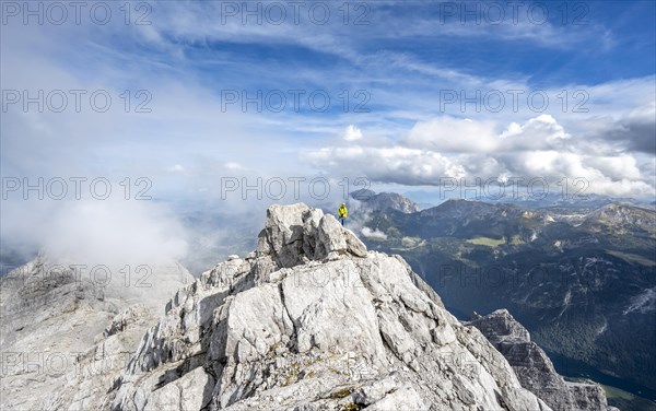 Mountaineer on the rocky summit of the Watzmann Mittelspitze, Watzmann crossing, view of mountain panorama, Berchtesgaden National Park, Berchtesgaden Alps, Bavaria, Germany, Europe