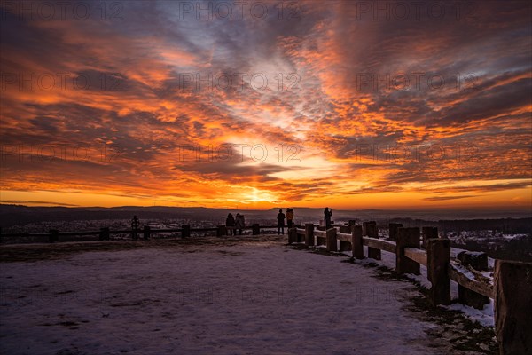 People watching an impressive sunset in the snowy terrain, Wallberg, Pforzheim, Germany, Europe