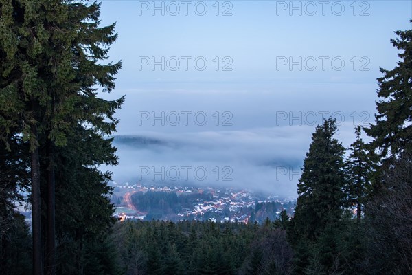 Landscape on the Grosser Feldberg, Taunus volcanic region. A cloudy, sunny winter day, meadows, hills, snow and forests with a view of the winter sunset. Hesse, Germany, Europe