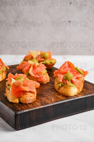 Closeup view of sandwich with salmon and mashed avocado