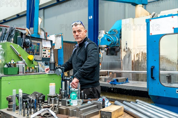 Photo with copy space of an engineer working using a cnc machine in a logistics factory