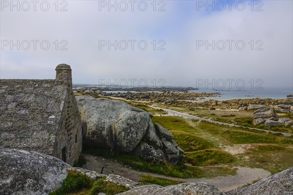 Former village of Meneham on the Atlantic coast with house between granite rocks, coast on the English Channel, Menez Ham, Kerlouan, department Finistere Penn ar Bed, region Bretagne Breizh, France, Europe