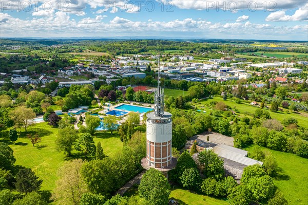 Aerial view of a park with a tower, outdoor swimming pool next to urban buildings and clouds in the sky, new water tower, Pforzheim, Germany, Europe