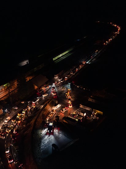 Night view of an illuminated road full of tractors and people, farmers protest, Black Forest, Bad Teinach, Germany, Europe