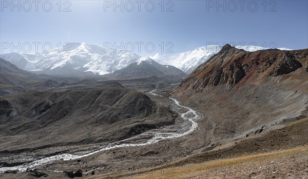 Valley with river Achik Tash, behind glaciated and snow-covered mountain peak Pik Lenin and Pik of the XIX Party Congress of the CPSU, Trans Alay Mountains, Pamir Mountains, Osh Province, Kyrgyzstan, Asia