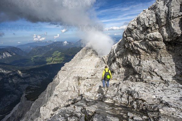 Mountaineer on a narrow rocky ridge, Watzmann crossing to Watzmann Mittelspitze, view of mountain panorama, Berchtesgaden National Park, Berchtesgaden Alps, Bavaria, Germany, Europe