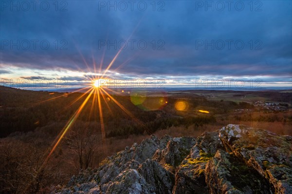 Landscape at the Grosser Zacken, Taunus volcanic region. A cloudy, sunny autumn day, meadows, hills, fields and forests with a view of the sunset. Hesse, Germany, Europe